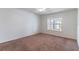 This bedroom has carpet flooring and a window with natural light exposure at 4770 Cypress Forest Ln, St Cloud, FL 34772