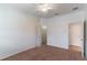 Bedroom featuring carpet floors, ceiling fan and walk-in closet with open door at 4770 Cypress Forest Ln, St Cloud, FL 34772