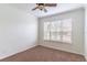 Bedroom featuring carpet flooring, a ceiling fan, and natural light from a window with blinds at 4770 Cypress Forest Ln, St Cloud, FL 34772