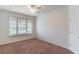 Cozy bedroom featuring a ceiling fan, carpet flooring, and a window with blinds at 4770 Cypress Forest Ln, St Cloud, FL 34772