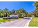 Scenic entrance to Cypress Preserve with lush landscaping and swaying palm trees at 4770 Cypress Forest Ln, St Cloud, FL 34772