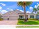 Beautiful single-story home with a three-car garage, lush lawn, tasteful landscaping, and mature palm trees at 4770 Cypress Forest Ln, St Cloud, FL 34772