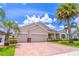 Inviting single-story home featuring a three-car garage, brick paver driveway and beautifully landscaped front yard at 4770 Cypress Forest Ln, St Cloud, FL 34772