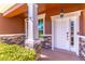 Covered entryway featuring stone accents, exterior lighting, and stylish white front door at 4770 Cypress Forest Ln, St Cloud, FL 34772