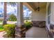 Inviting front porch with stone accents, manicured shrubs and an elegant hanging light fixture at 4770 Cypress Forest Ln, St Cloud, FL 34772