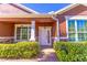 Inviting front porch with stone accents, manicured hedges, and a stylish white front door at 4770 Cypress Forest Ln, St Cloud, FL 34772