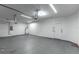 Spacious garage features concrete flooring, white walls, and a door to the outside at 4770 Cypress Forest Ln, St Cloud, FL 34772