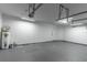 Spacious garage features concrete flooring, white walls, and a door to the outside at 4770 Cypress Forest Ln, St Cloud, FL 34772