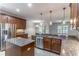 Gourmet kitchen with granite counters, stainless steel appliances, and an island with a sink at 4770 Cypress Forest Ln, St Cloud, FL 34772