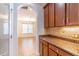 Kitchen area with wood cabinets and granite countertops leading to dining room at 4770 Cypress Forest Ln, St Cloud, FL 34772