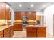 Well-lit kitchen featuring wood cabinetry, stainless appliances, and granite countertops at 4770 Cypress Forest Ln, St Cloud, FL 34772