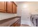 Laundry room features counter space, cabinets, and stainless steel washer and dryer at 4770 Cypress Forest Ln, St Cloud, FL 34772