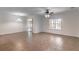 Spacious living area with tile floors, sliding glass doors, and a ceiling fan at 4770 Cypress Forest Ln, St Cloud, FL 34772