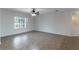 Empty room featuring tile flooring, large window with natural light, and ceiling fan at 4770 Cypress Forest Ln, St Cloud, FL 34772