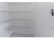 Walk-in pantry with white wire shelving for ample storage at 4770 Cypress Forest Ln, St Cloud, FL 34772