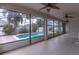 Enclosed patio featuring screens, ceiling fans, and brick pavers leading to the beautiful private swimming pool at 4770 Cypress Forest Ln, St Cloud, FL 34772