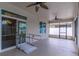 Covered patio with ceiling fans, wheelchair ramp and sliding glass door offer comfort and accessibility at 4770 Cypress Forest Ln, St Cloud, FL 34772