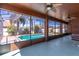 Screened-in pool area with ceiling fans, privacy walls, tiled flooring, pool and backyard views at 4770 Cypress Forest Ln, St Cloud, FL 34772