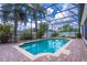 Screened-in pool with brick paver deck, surrounded by lush landscaping, offering a private backyard oasis at 4770 Cypress Forest Ln, St Cloud, FL 34772