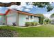 Side view of a one-story home showing the attached garage, lawn, and minimal landscaping at 4792 Indian Gap Dr, Orlando, FL 32812