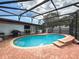 Beautiful screened-in pool with brick deck, great for outdoor relaxation and entertainment by the poolside at 4792 Indian Gap Dr, Orlando, FL 32812