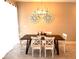 Dining room features modern chandelier, seating and decorative wall art at 4949 Windermere Ave, Kissimmee, FL 34746