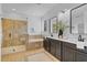 Bathroom featuring glass shower, soaking tub, and double vanity at 5116 Sorrento W Blvd, St Cloud, FL 34771