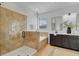 Bathroom featuring glass shower, soaking tub, and dark cabinets at 5116 Sorrento W Blvd, St Cloud, FL 34771