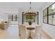 A bright dining room is illuminated by a modern chandelier and features access to the yard at 5116 Sorrento W Blvd, St Cloud, FL 34771