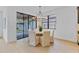 A dining area is brightened by a modern chandelier with glass doors opening to the patio at 5116 Sorrento W Blvd, St Cloud, FL 34771