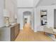 Hallway view with an arched opening, a lovely hall table with lamps, and hardwood floors at 5116 Sorrento W Blvd, St Cloud, FL 34771