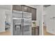 Stainless steel refrigerator and dark cabinets with granite countertops and modern appliances at 5116 Sorrento W Blvd, St Cloud, FL 34771