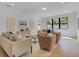 A well-lit living room features neutral-toned furniture and large windows at 5116 Sorrento W Blvd, St Cloud, FL 34771