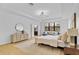 Light-filled main bedroom with a seating area, a large window and hardwood floors at 5116 Sorrento W Blvd, St Cloud, FL 34771