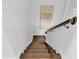 View of a hardwood staircase with white risers, leading downwards at 5116 Sorrento W Blvd, St Cloud, FL 34771