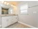 A full bathroom features a double sink with a granite countertop and bright vanity lighting at 514 Bristol Cir, Kissimmee, FL 34758