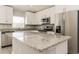 Modern kitchen with granite countertops, stainless steel appliances, and white cabinets at 514 Bristol Cir, Kissimmee, FL 34758