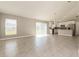 Open-concept living room with tile flooring, bright natural light and modern light fixtures at 514 Bristol Cir, Kissimmee, FL 34758