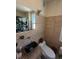 Tiled bathroom with unique vessel sink, travertine tile, and modern fixtures at 529 Hillside Nw Ave, Daytona Beach, FL 32118