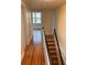 Upstairs hallway showing hardwood floors and natural light streaming from a nearby window at 529 Hillside Nw Ave, Daytona Beach, FL 32118