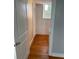 Hallway with wood floors, closet and window view at 529 Hillside Nw Ave, Daytona Beach, FL 32118