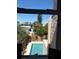 Backyard pool view from a window, showing a clear blue pool and surrounding landscaping at 529 Hillside Nw Ave, Daytona Beach, FL 32118