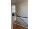 View of stairs from an upstairs landing with hardwood floors and white railings at 529 Hillside Nw Ave, Daytona Beach, FL 32118