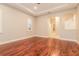 An empty bedroom boasting wood floors, tray ceilings and an arched entry way at 5543 Grey Hawk Ln, Lakeland, FL 33810