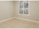 Neutral bedroom with tiled floors, a window with lots of natural light, and neutral paint at 5543 Grey Hawk Ln, Lakeland, FL 33810