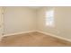 Neutral bedroom with beige carpeting, natural light, and ample closet space at 5543 Grey Hawk Ln, Lakeland, FL 33810