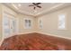 This bright bedroom features wood floors, a tray ceiling, and plenty of natural light at 5543 Grey Hawk Ln, Lakeland, FL 33810