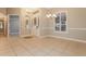 Elegant foyer with tiled flooring, decorative light fixtures, and a clear view to the door at 5543 Grey Hawk Ln, Lakeland, FL 33810