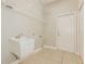 Functional laundry room equipped with a utility sink and storage shelves at 5543 Grey Hawk Ln, Lakeland, FL 33810