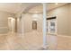 Spacious living room featuring tiled flooring, elegant columns, and a bright patio entrance at 5543 Grey Hawk Ln, Lakeland, FL 33810